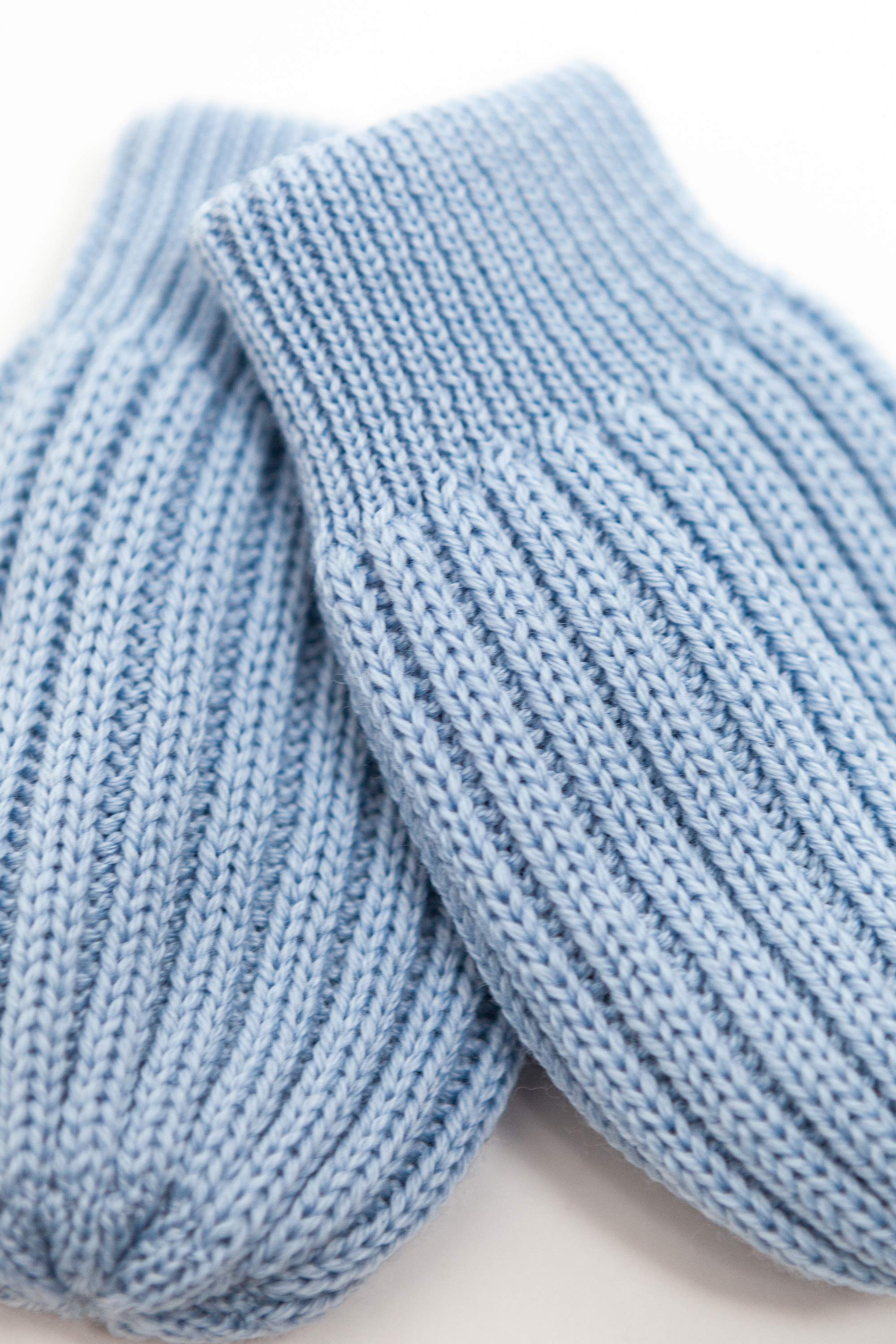 blue merino wool baby mittens worn – tiny hands kept warm naturally
