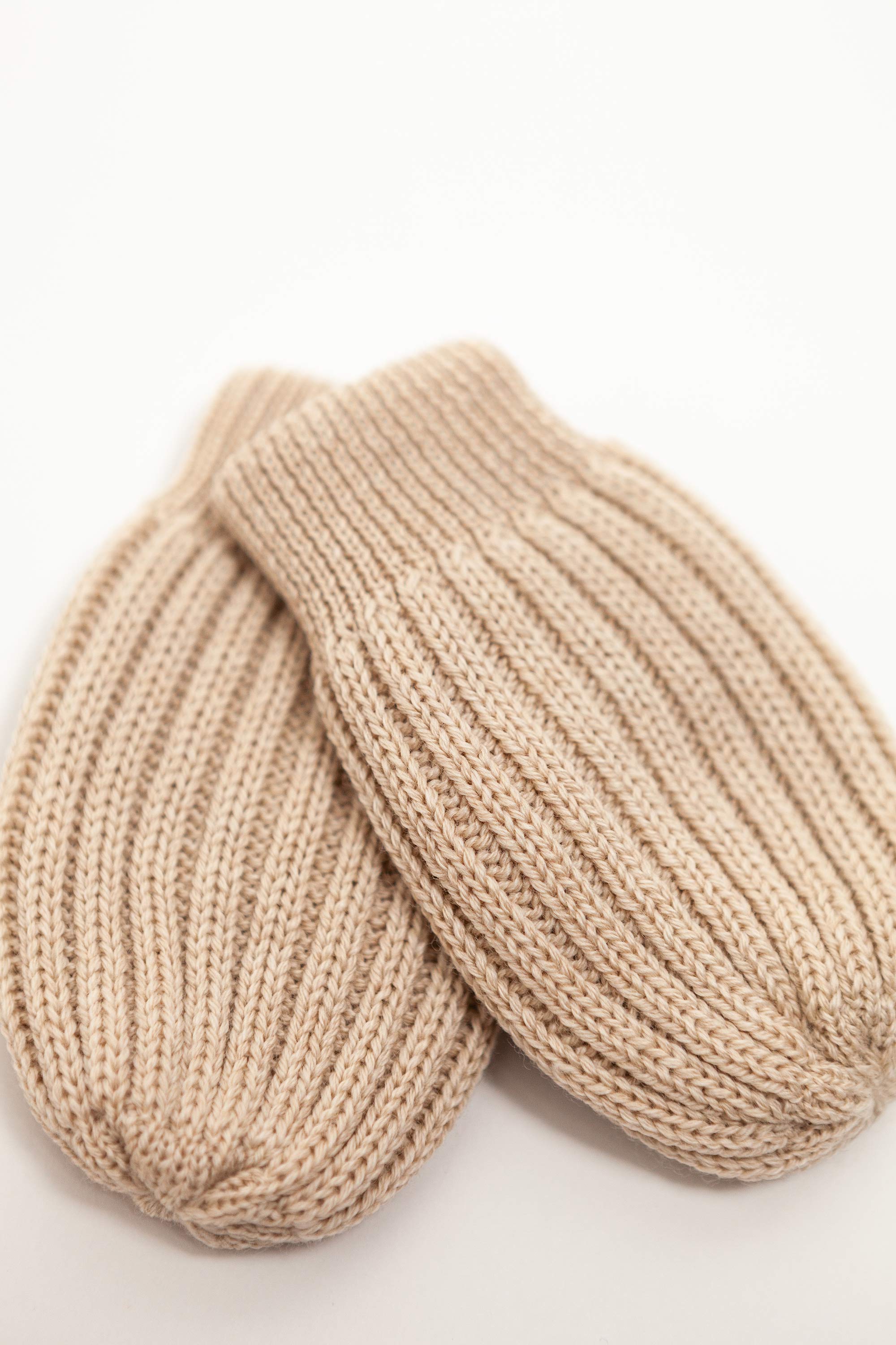 beige merino wool baby mittens worn – tiny hands kept warm naturally